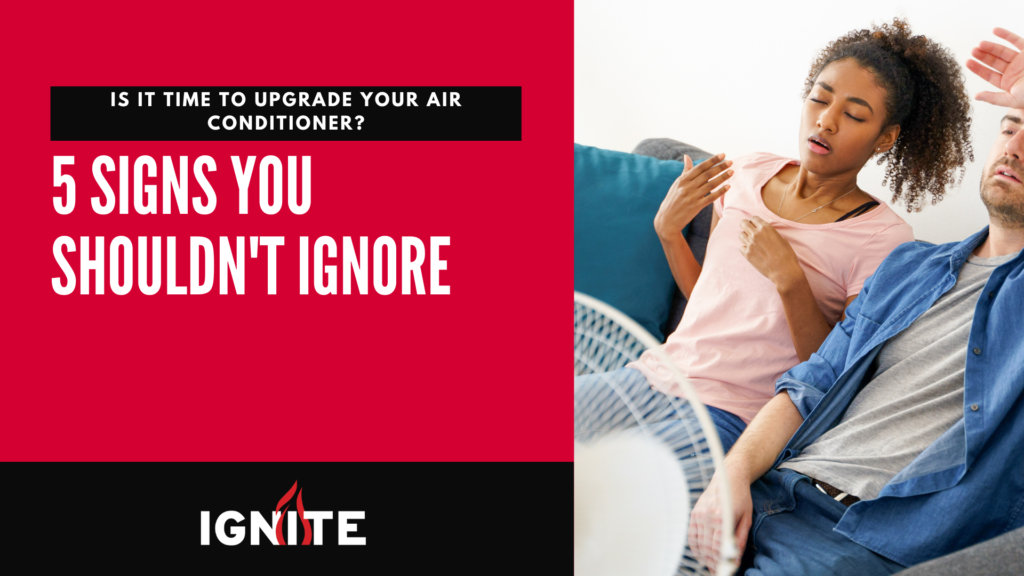 Overheated couple sitting near fan highlights need for air conditioner upgrade. Text reads '5 Signs You Shouldn't Ignore' by Ignite Heating and Air Conditioning, Edmonton HVAC experts.